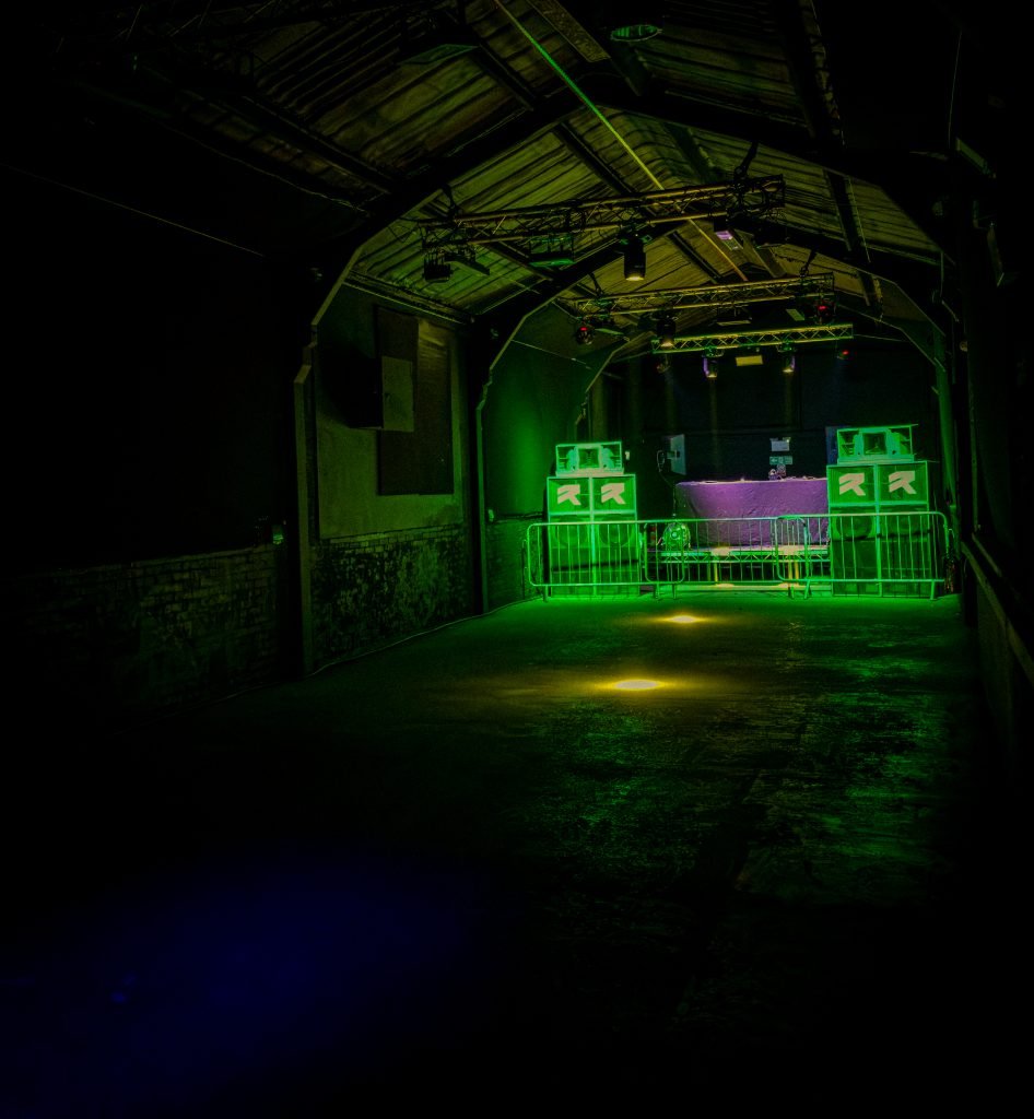 The main room at Dryad Works, Sheffield, lit green before a show